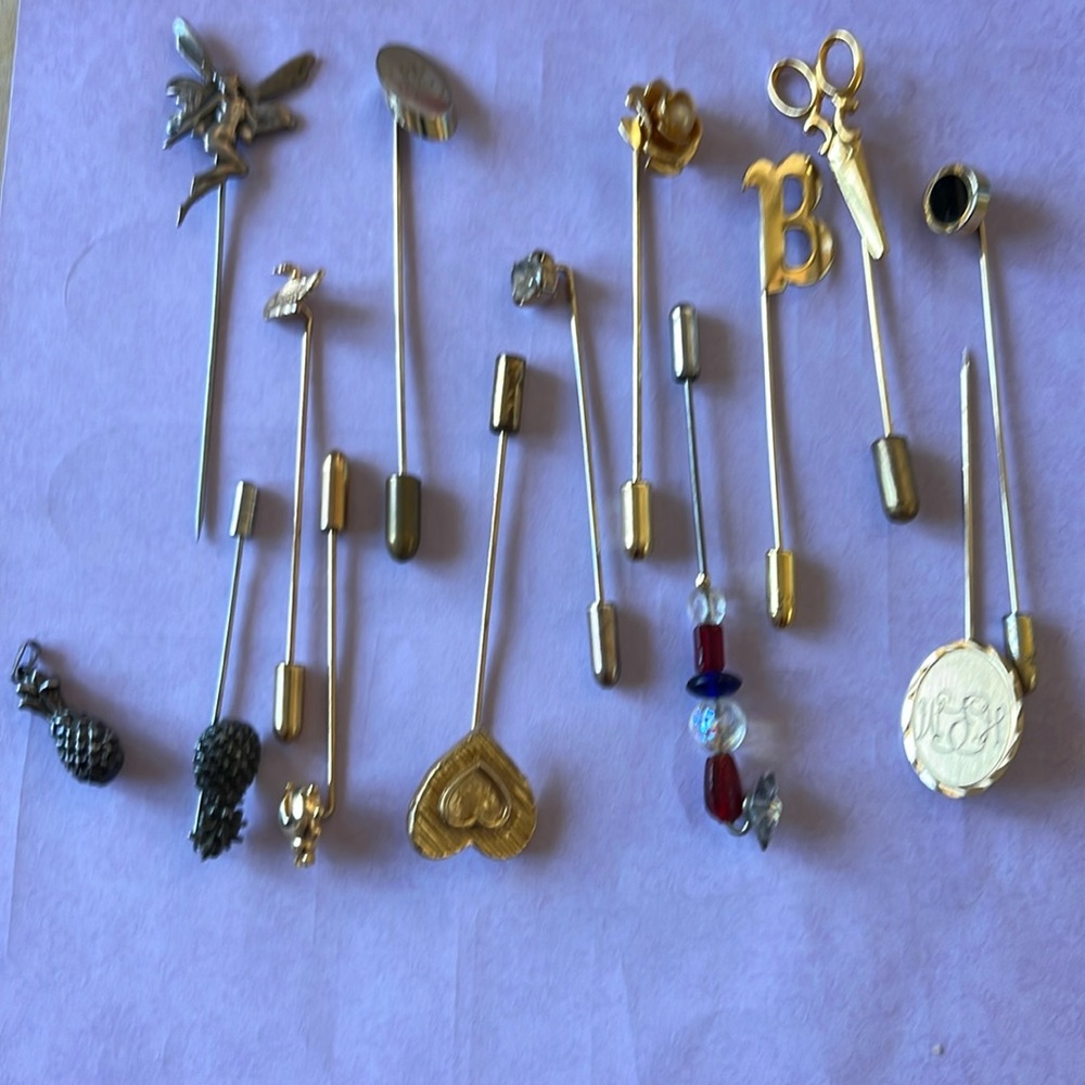 Lot of 13 goldtone stickpins with one little pineapple pendant